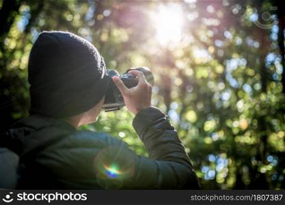 Close up Photographer is taking a picture in the forest.Photographer,travel,tourist