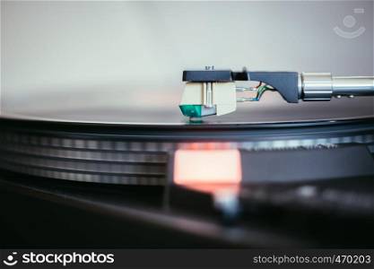 Close up picture of a record player, playing a record
