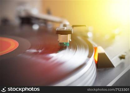Close up picture of a record player, playing a record. Sunbeam.
