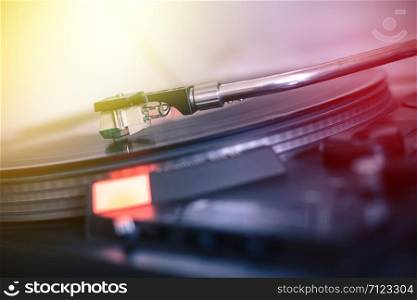 Close up picture of a record player, playing a record. Sunbeam.