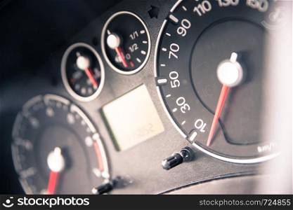 Close up picture of car dashboard with instruments and tachometer