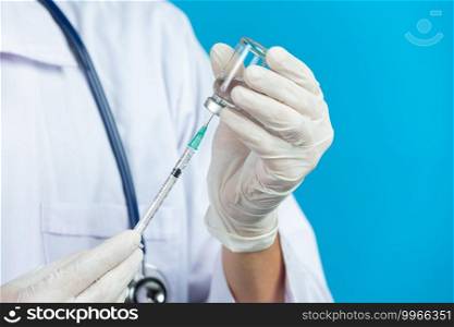 close up picture of doctor’s hands holding hypodermic syringe