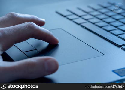 Close up picture of hands using a notebook touchpad