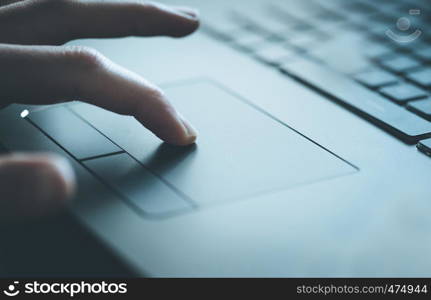 Close up picture of hands using a notebook touchpad