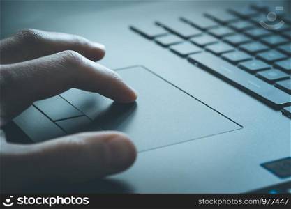 Close up picture of hands using a notebook touchpad