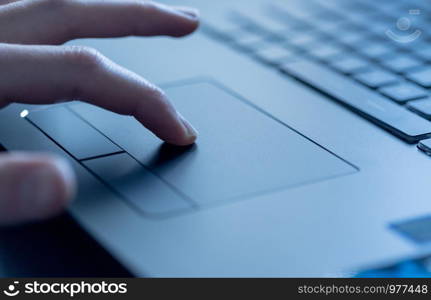 Close up picture of hands using a notebook touchpad