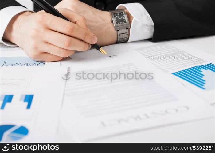 close up picture of man hand signing contract