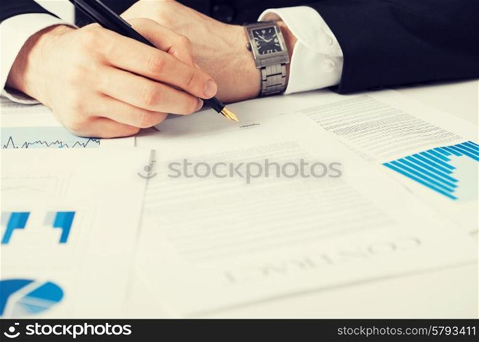 close up picture of man hand signing contract