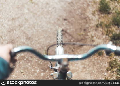 Close up picture of retro bike tire, blurry handlebar, summer day