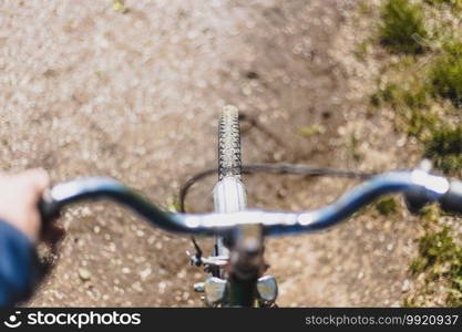 Close up picture of retro bike tire, blurry handlebar, summer day