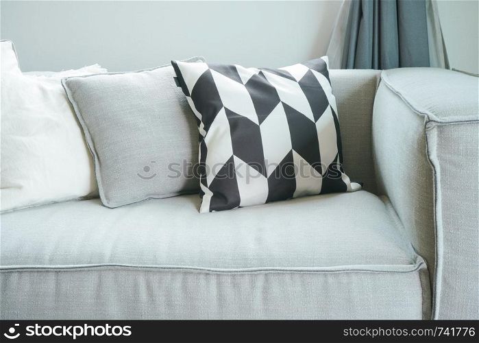 Close up pillows on comfortable sofa in living room
