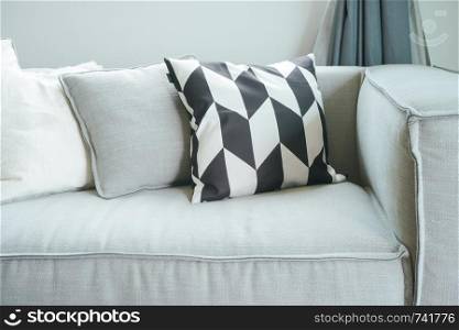 Close up pillows on comfortable sofa in living room
