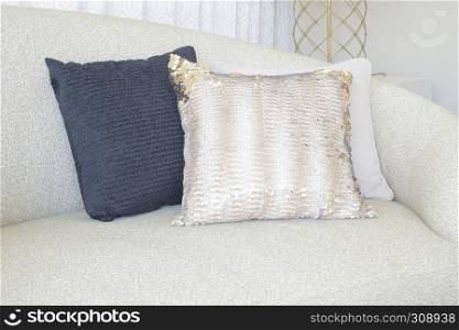 Close up pillows on curve sofa in living room