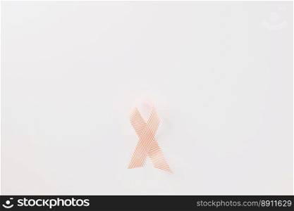 Close up pink awareness ribbon of International World Cancer Day c&aign isolated on white background with copy space, concept of medical and health care support, 4 February