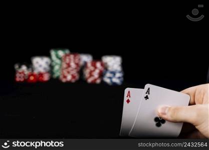close up player s hand holding two aces playing cards