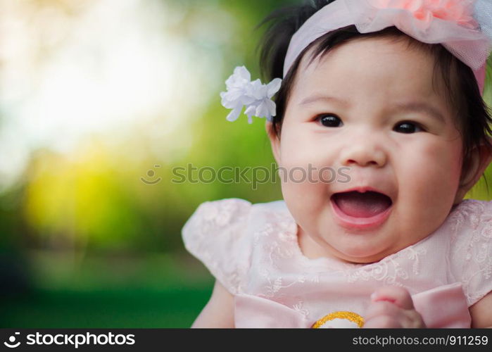 Close up portrait Asian cute baby girl with Natural light background