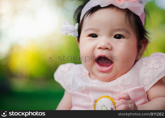 Close up portrait Asian cute baby girl with Natural light background