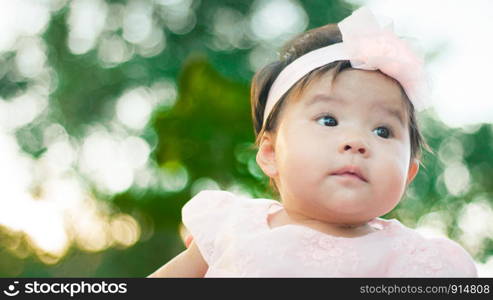 Close up portrait Asian cute baby girl with Natural light background