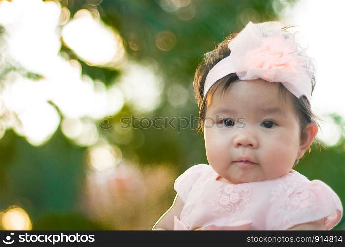 Close up portrait Asian cute baby girl with Natural light background