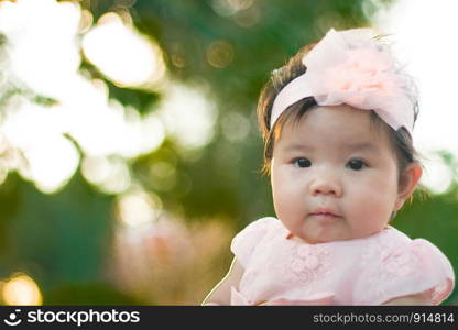 Close up portrait Asian cute baby girl with Natural light background