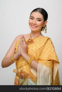 Close up, Portrait beautiful Asian woman in traditional Thai dress costume smile and pose gracefully on white background, copy space