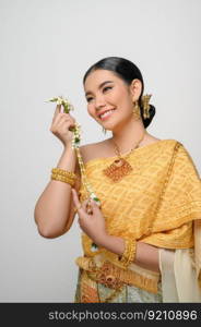 Close up, Portrait beautiful Asian woman in traditional Thai dress costume smile and holding a garland with gracefully pose on white background