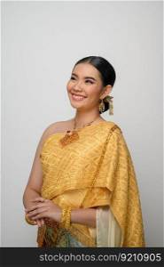 Close up, Portrait beautiful Asian woman in traditional Thai dress costume smile and pose gracefully on white background