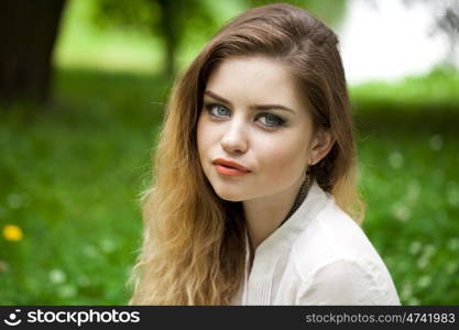 Close up portrait of a beautiful brunette woman, outdoors