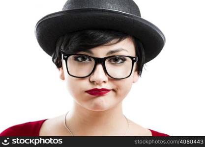 Close-up portrait of a beautiful girl bored with something, wearing a hat and nerd glasses