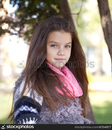 Close up portrait of a beautiful nine year old little girl in autumn park