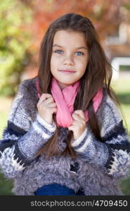 Close up portrait of a beautiful nine year old little girl in autumn park