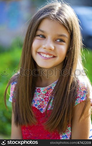 Close up portrait of a beautiful nine year old little girl in autumn park