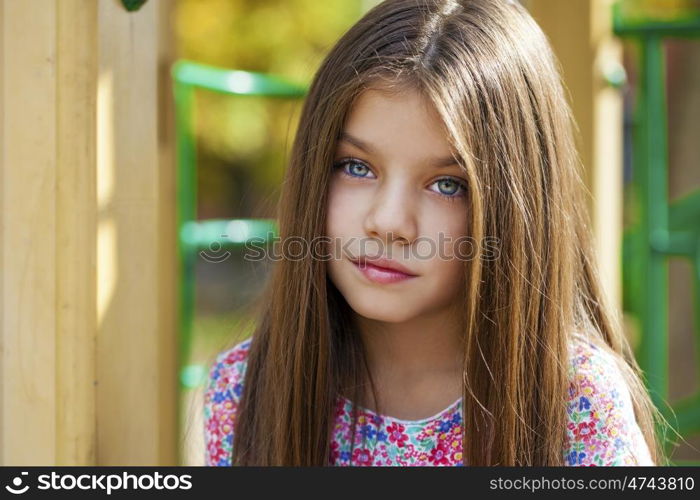 Close up portrait of a beautiful nine year old little girl in autumn park