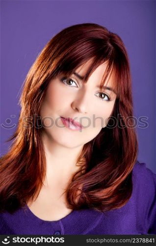 Close-up portrait of a beautiful woman with a lovely espression, over a violet background