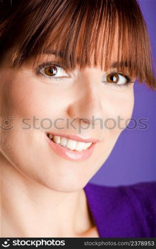 Close-up portrait of a beautiful woman with a lovely espression, over a violet background
