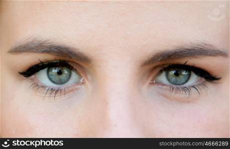 Close-up portrait of a beautiful woman with blue eyes, looking at camera