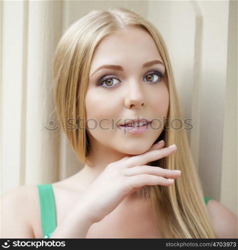 Close up portrait of a beautiful young blonde woman, indoor
