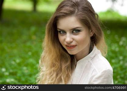Close up portrait of a beautiful young blonde woman, outdoors