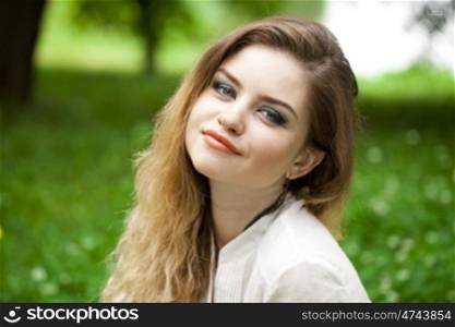 Close up portrait of a beautiful young blonde woman, outdoors