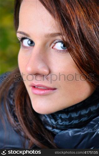 close up portrait of a beautiful young brown haired woman looking at camera from below