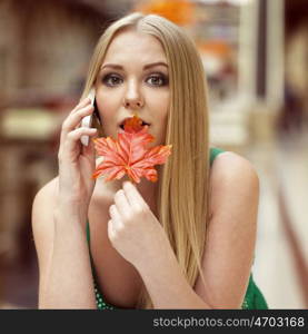 Close up portrait of a beautiful young girl talking on his cell phone in a shopping center