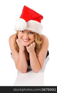 close up portrait of a blond cute girl wearing a christmas hat and laying down on a white floor looking in camera wirh a smile