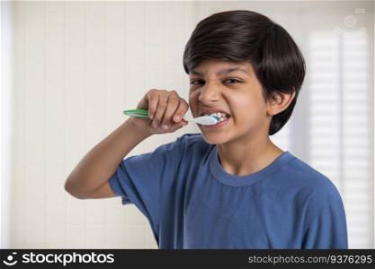 Close-up portrait of a boy brushing his teeth