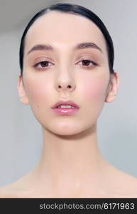 Close-up portrait of a frontal female model with natural make-up.