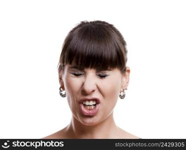 Close-up portrait of a funny woman with a upset expression against white background