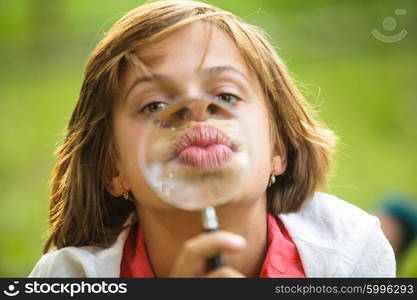 Close-up portrait of a girl that plays with magnifying glass. Funny lips