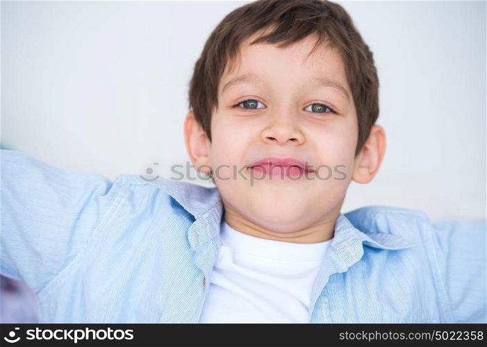 Close up portrait of a kid smiling to the camera