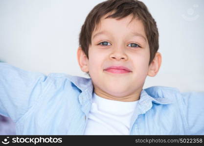 Close up portrait of a kid smiling to the camera