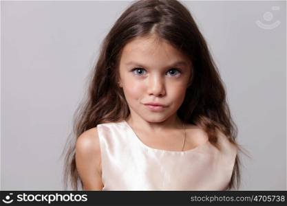 close-up portrait of a little amazing girl with blue eyes and opening mouth isolated on white