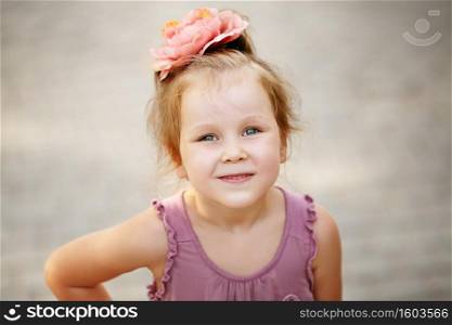 Close-up portrait of a lovely urban little girl outdoors